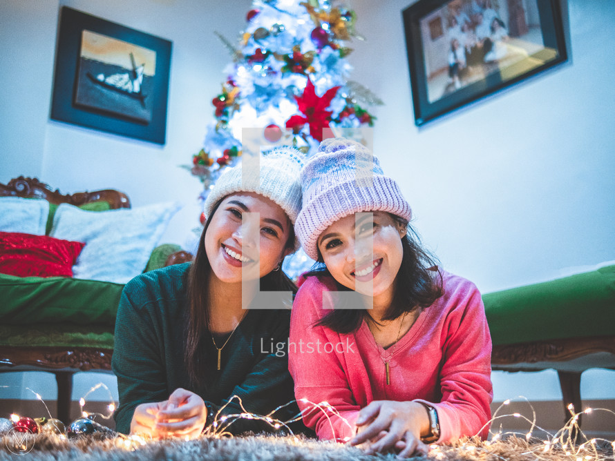 smiling sisters at Christmas 