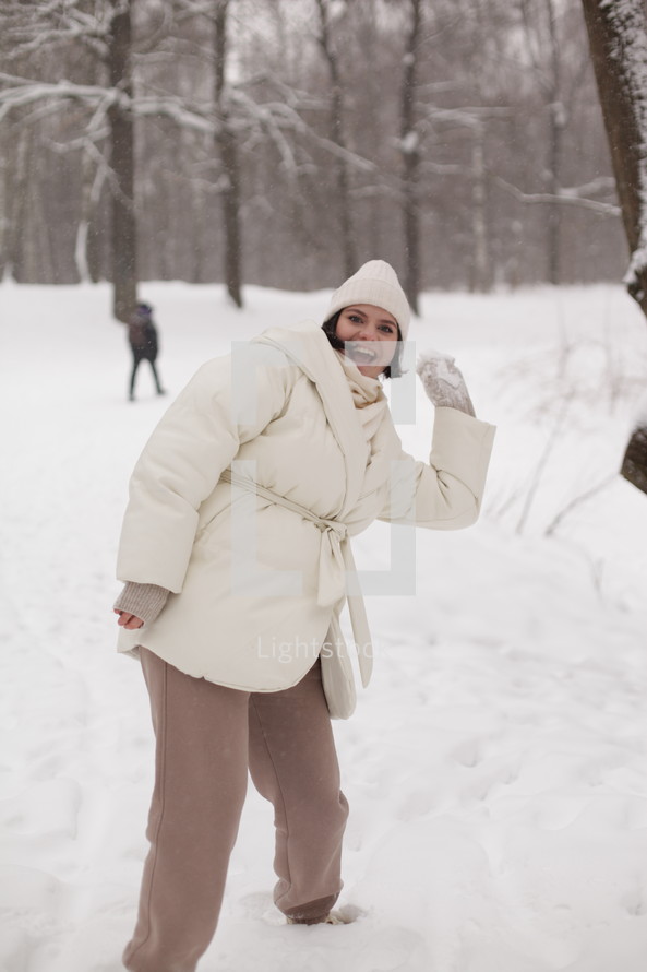 a woman throwing snowballs 