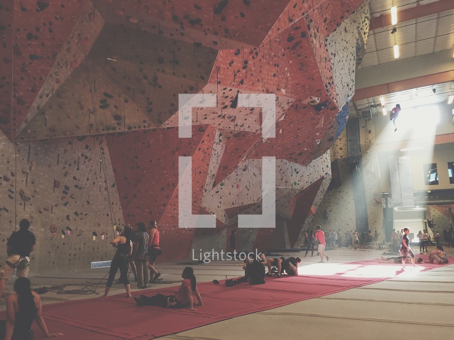 people rock climbing in an indoor facility 