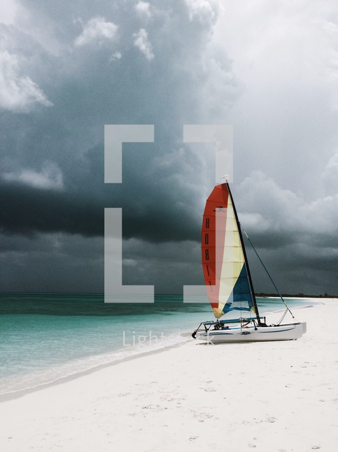 catamaran on a beach and a stormy sky
