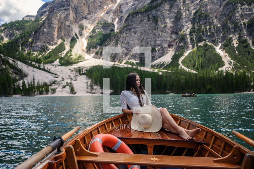 a young woman on a rowboat on vacation relaxing 