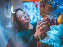 a woman decorating a Christmas 