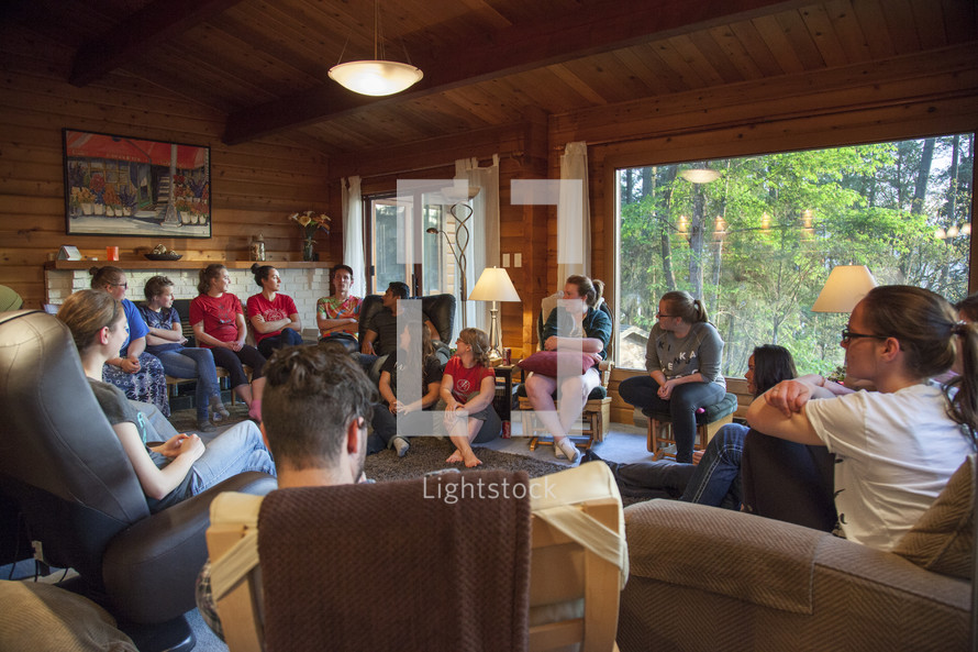 teens on a retreat sitting around having a discussion 