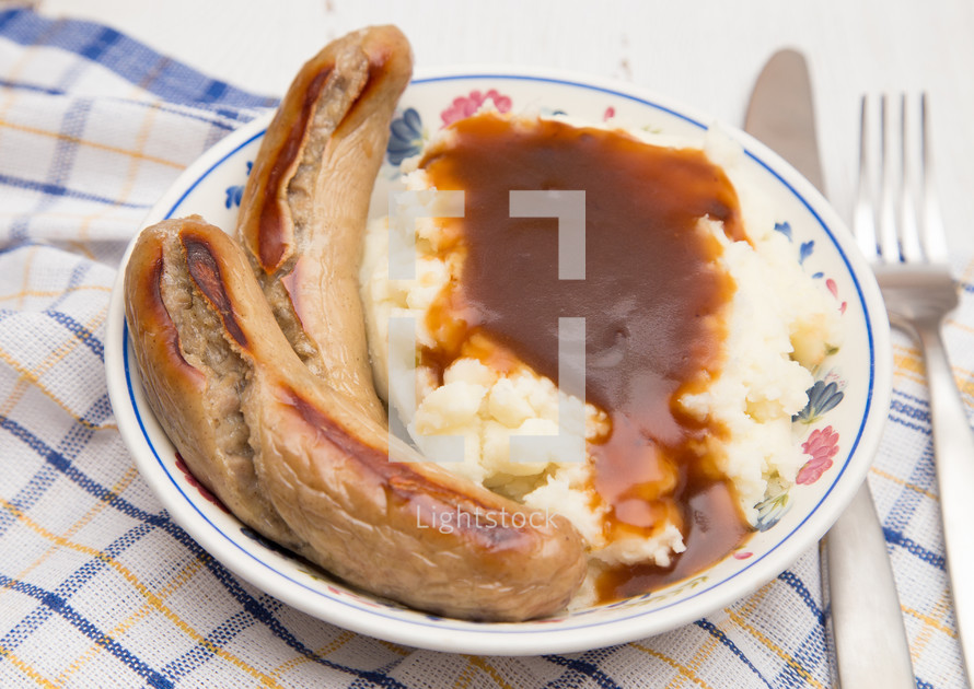 British Classic of Bangers and Mash on a White Background