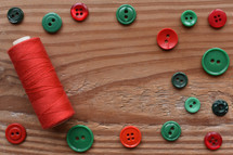 red and green buttons and thread 