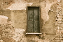 Wooden window on an adobe house adjacent to the bridge of sighs