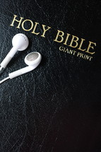 Holy Bible with earbuds 