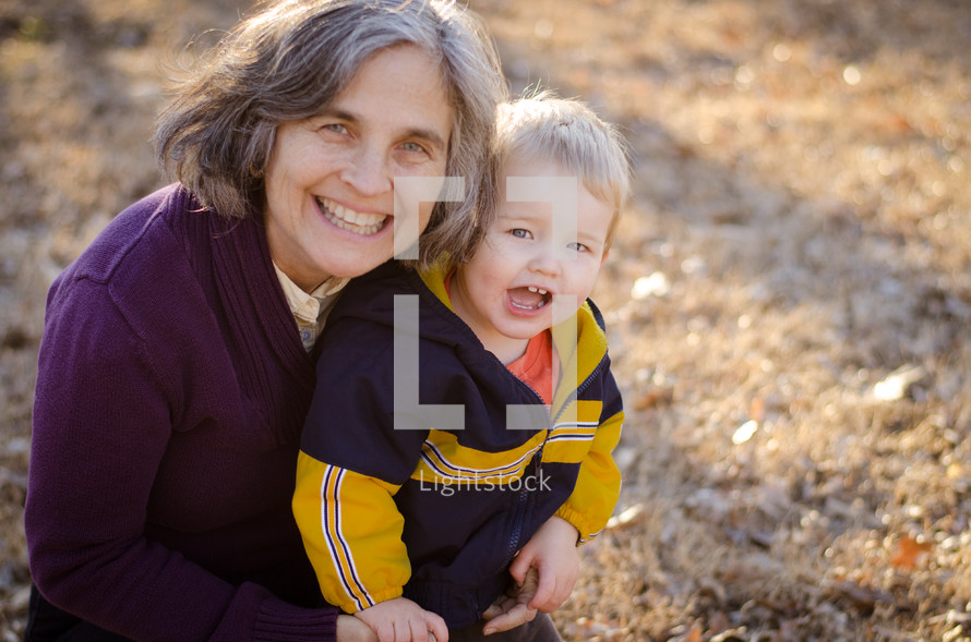 a portrait of a grandmother and grandson outdoors 