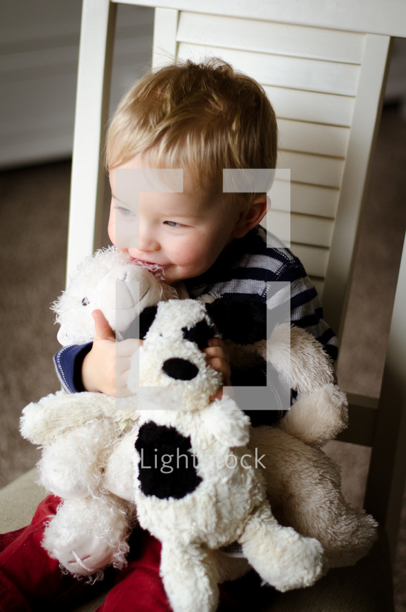 a child snuggling stuffed animals 