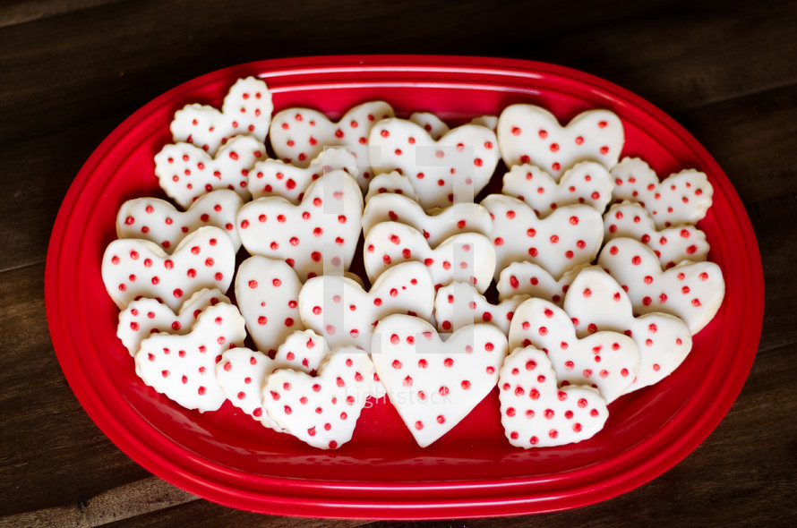 heart shaped cookies on a red platter 