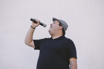 a man singing into a microphone 