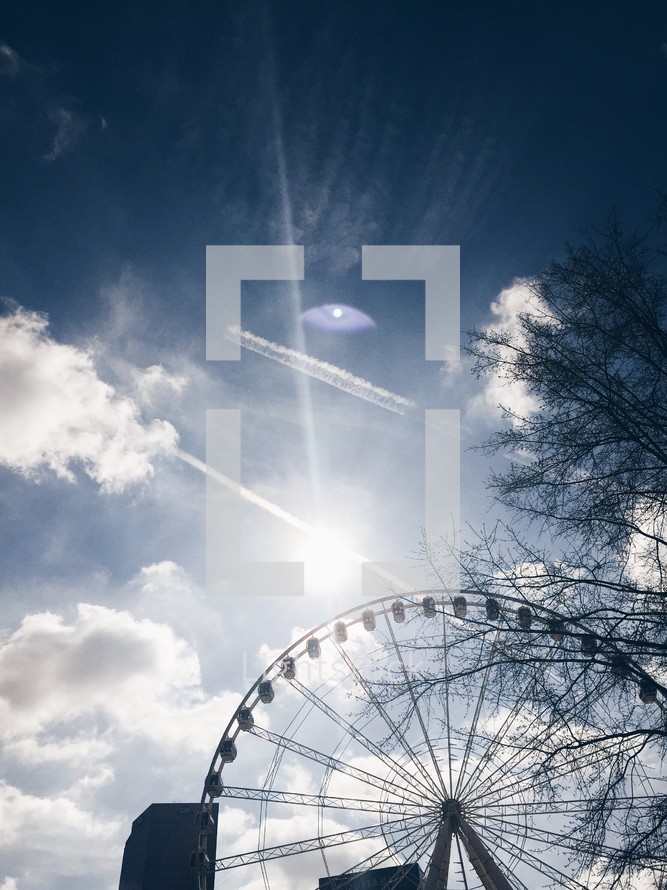 ferris wheel silhouette against the sky 