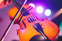 Violin on a lighted stage.