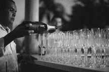 man pouring champagne at a wedding reception 