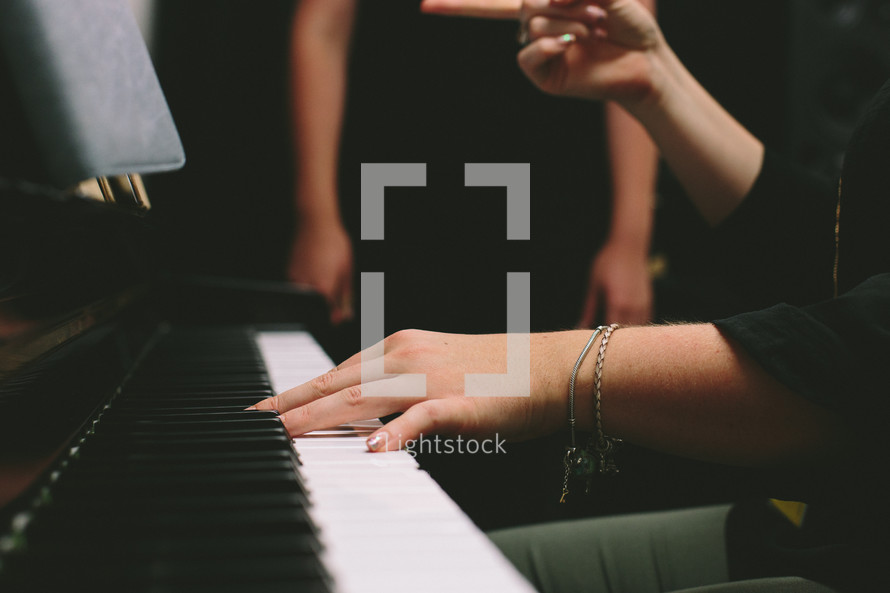 Choir director at a piano.