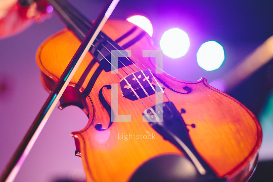 Violin on a lighted stage.