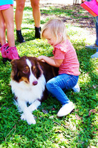 toddler and dog on the farm