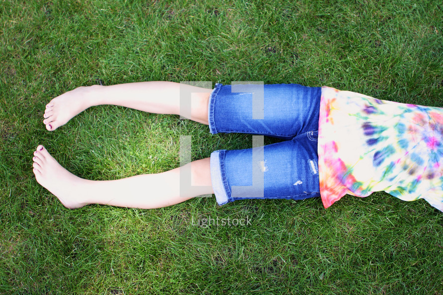 fun photo of tie dyed shirt and shorts in the park