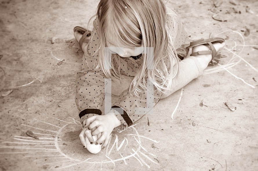 child coloring with sidewalk chalk