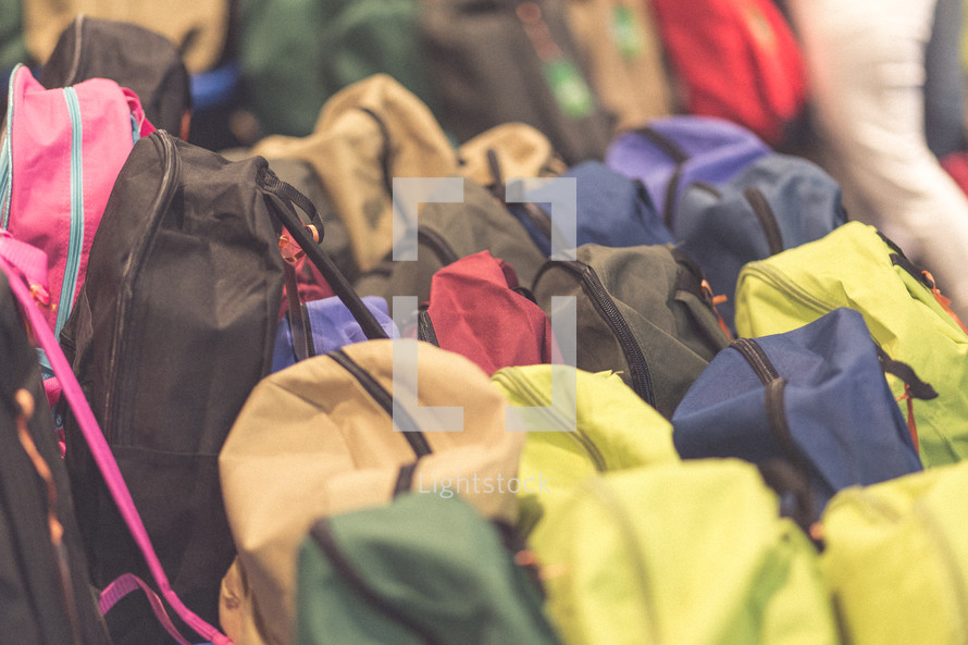 Many colorful backpacks.