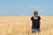 Woman standing in a wheat field.