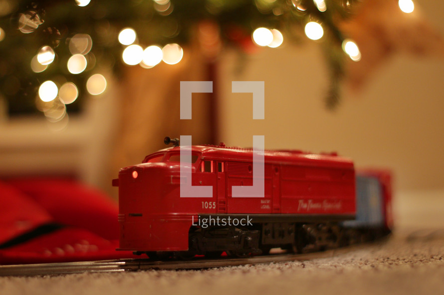 toy train under a Christmas tree 