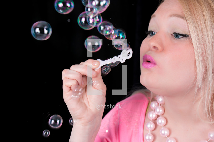 Girl blowing bubbles.