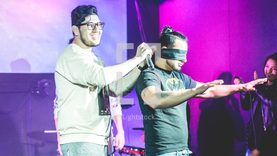blindfolded on stage 