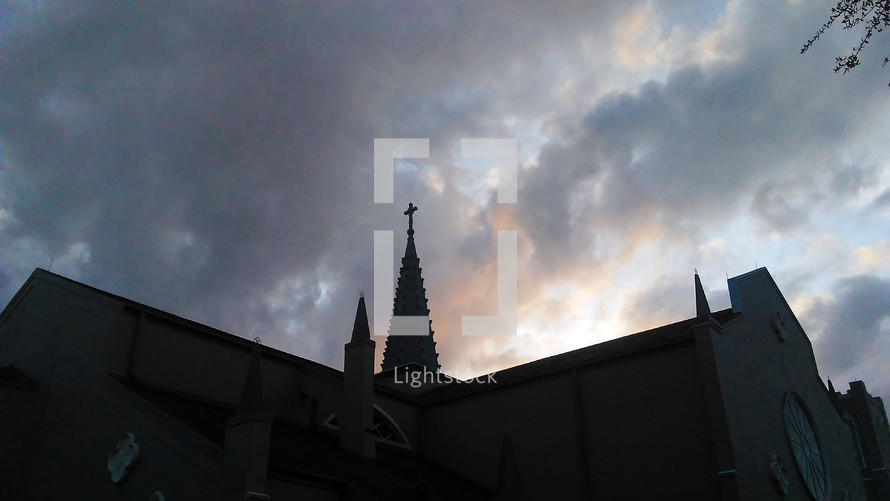 Chapel with steeple against the clouds