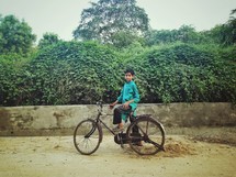 A child on a bicycle. 