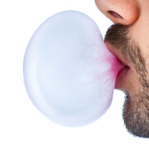man blowing a bubble 