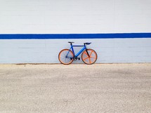 A bike parked against a wall. 