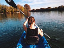 A woman paddling in a kayak 