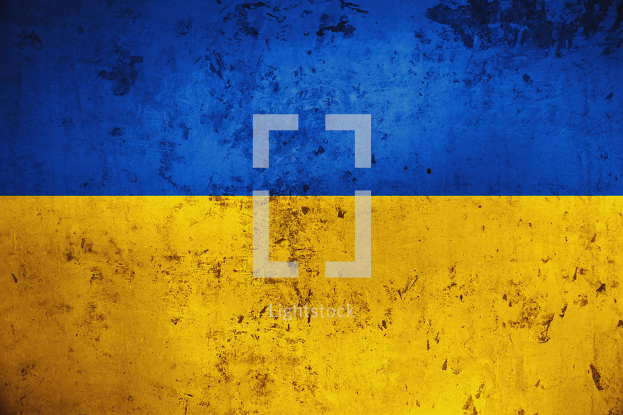 Grungy and damaged wall painted with blue and yellow paint like Ukrainian flag