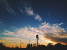 A water tower at sunset. 