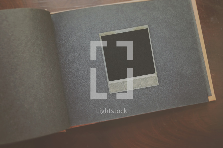 a blank polaroid on album page