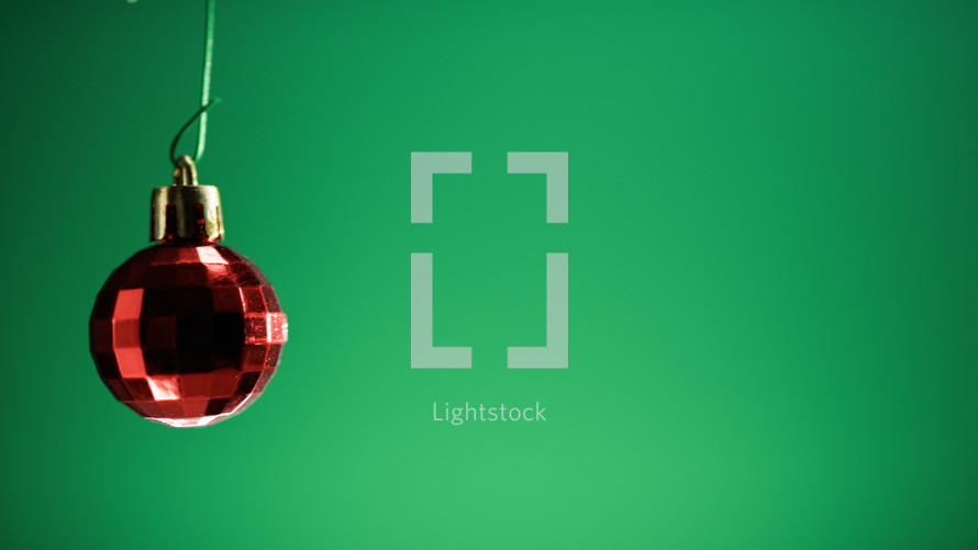 Red Christmas ball on green screen