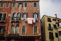 laundry on a clothesline hanging between windows in Venice 