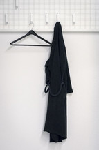 black rope hanging on a hook in a bathroom 
