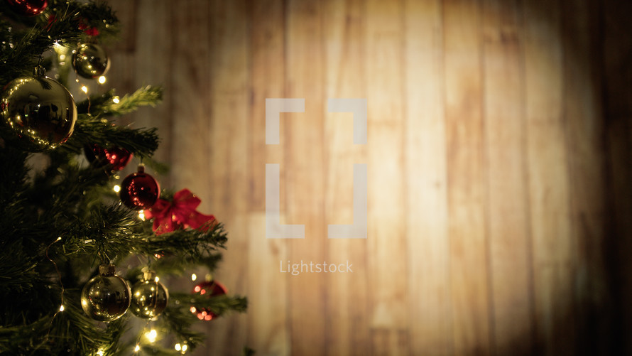 Christmas tree with a light wooden wall in the background