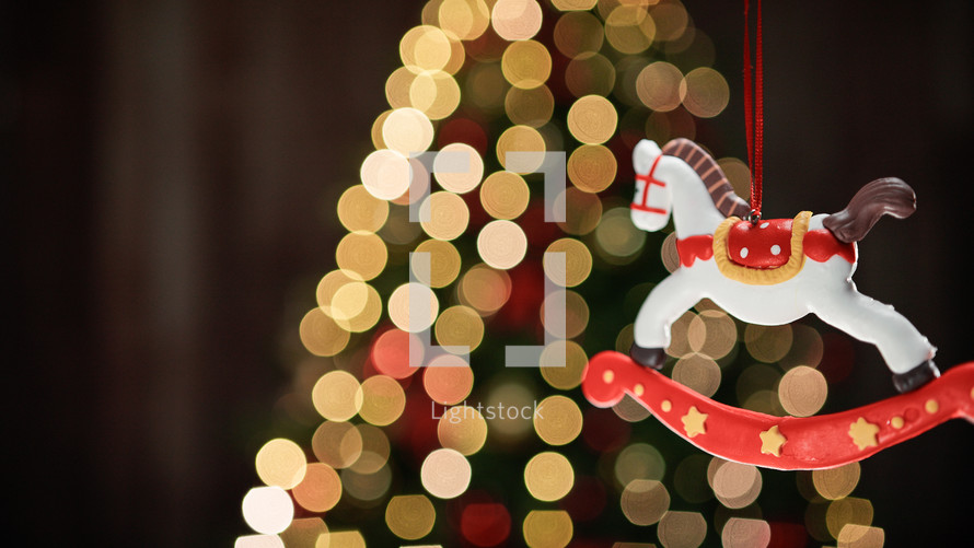 Carousel horse Christmas decoration with blurred tree