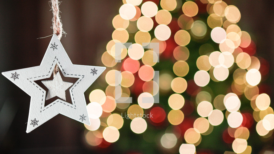 Christmas Star decoration with blurred tree