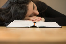 a woman sleeping on the pages of a book 