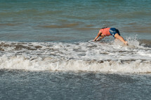 a girl diving into the ocean 
