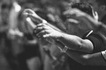 hands raised in worship at a worship service 