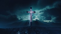 Cross of Jesus Christ on the top of the mountain with a storm background and electricity