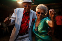 Elderly couple showing off dance moves at a party