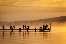 orange sky, sunset, water, lake, dock, silhouettes, people, outdoors, mist, sunrise, steam, fishing 