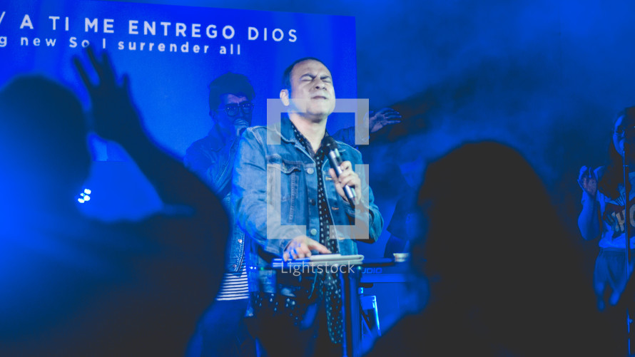 a man singing during a worship service 
