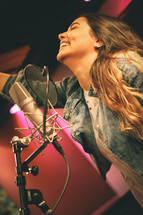 woman singing in a studio 